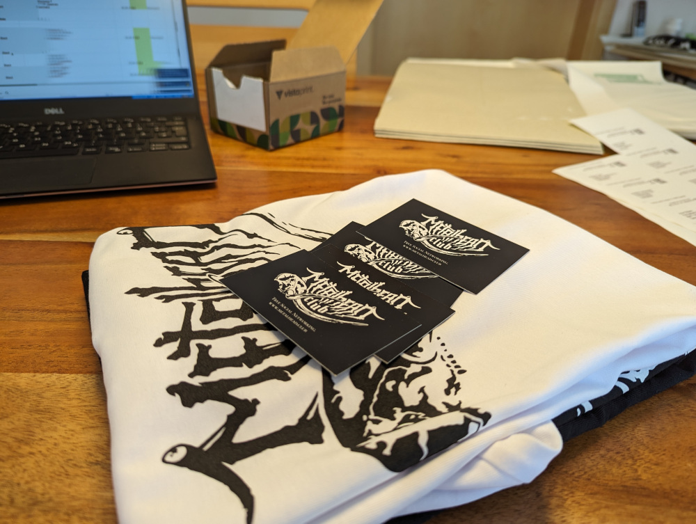 T-Shirts with metalhead.club business cards on top